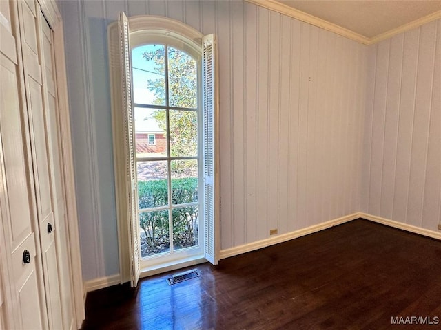 entryway featuring ornamental molding, dark wood-style flooring, visible vents, and baseboards