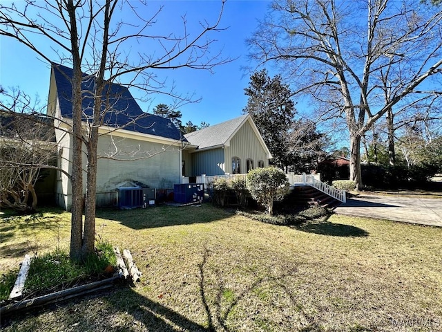 view of side of home with a yard