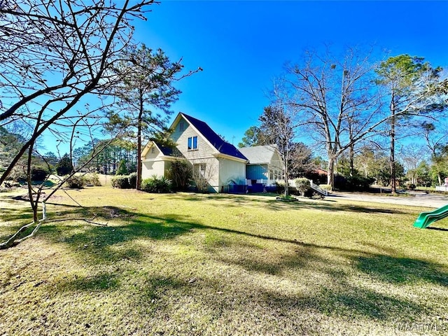 view of property exterior with a yard