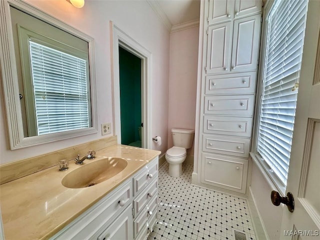 bathroom with visible vents, toilet, ornamental molding, tile patterned floors, and vanity