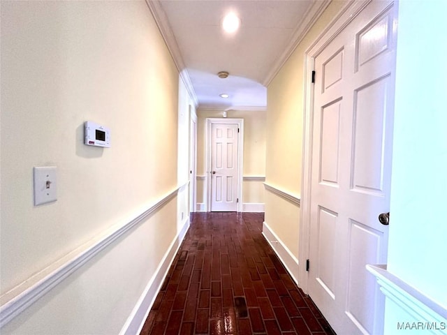 corridor featuring brick floor, baseboards, ornamental molding, and recessed lighting