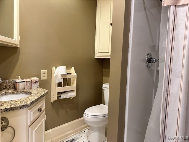 full bathroom featuring baseboards, toilet, tile patterned flooring, vanity, and a shower stall