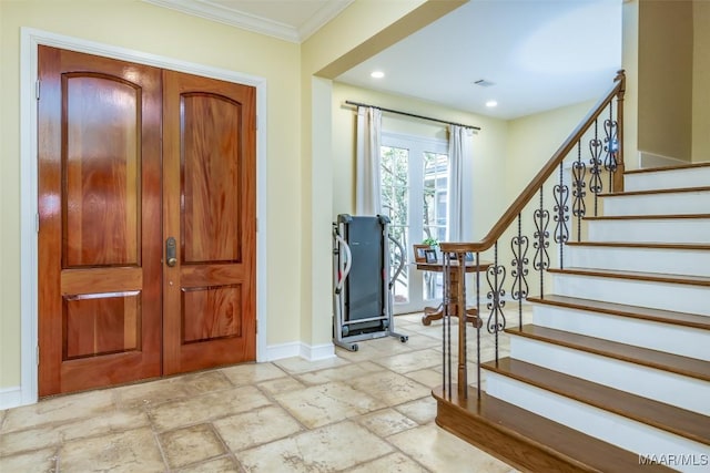 foyer with baseboards, stairway, crown molding, and stone tile floors