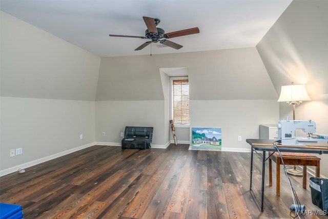 office area featuring dark wood-style floors, baseboards, vaulted ceiling, and a ceiling fan