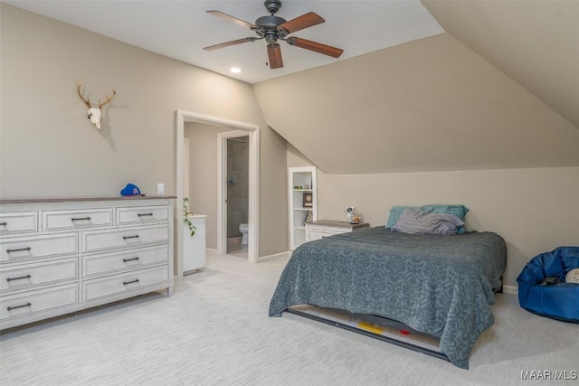 bedroom featuring lofted ceiling, ceiling fan, connected bathroom, light colored carpet, and baseboards