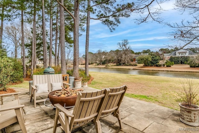 view of patio / terrace featuring a water view and a fire pit