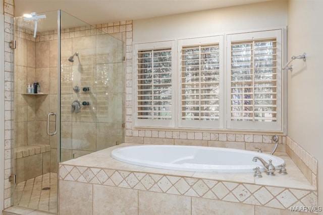 bathroom featuring a garden tub and a shower stall