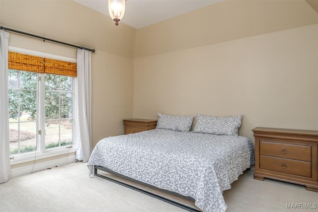 bedroom featuring light carpet