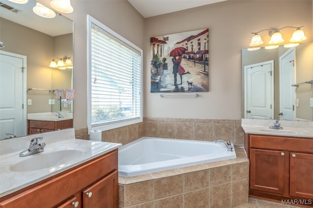 full bath featuring a garden tub, visible vents, two vanities, and a sink