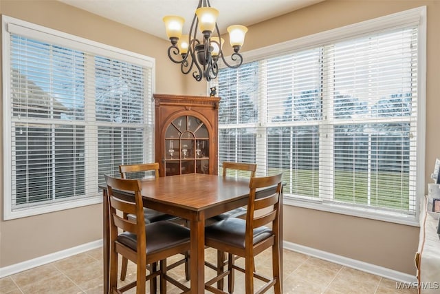 dining space featuring a chandelier, baseboards, and light tile patterned floors