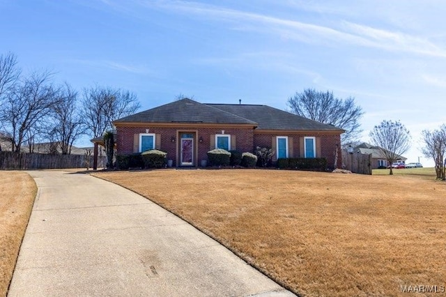 ranch-style home with brick siding, a front yard, and fence