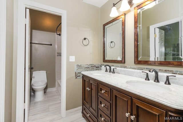 full bathroom featuring tasteful backsplash, a sink, toilet, and double vanity