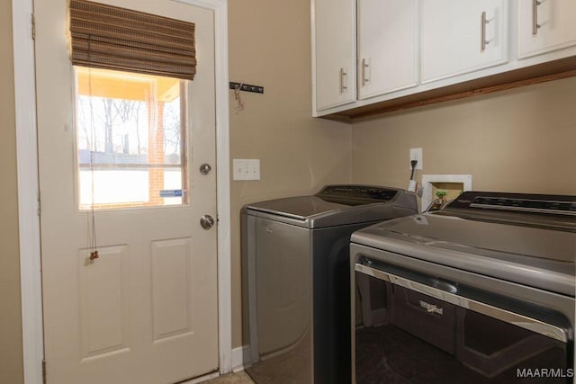 washroom featuring cabinet space and washing machine and clothes dryer