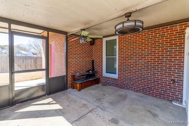 unfurnished sunroom with a wood stove