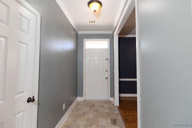 entryway featuring visible vents, crown molding, and baseboards