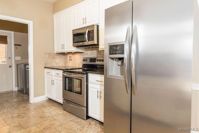 kitchen with baseboards, decorative backsplash, appliances with stainless steel finishes, stone finish flooring, and white cabinetry