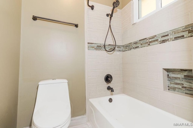 bathroom featuring bathing tub / shower combination and toilet