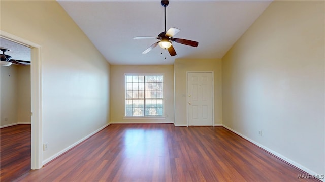 unfurnished room featuring lofted ceiling, ceiling fan, baseboards, and dark wood finished floors