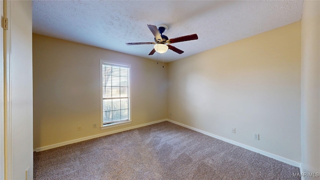 carpeted empty room with a textured ceiling, a ceiling fan, and baseboards