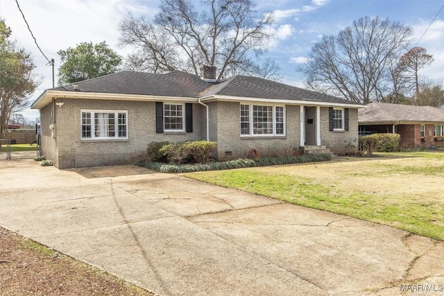 ranch-style home featuring brick siding, a chimney, a front yard, crawl space, and driveway