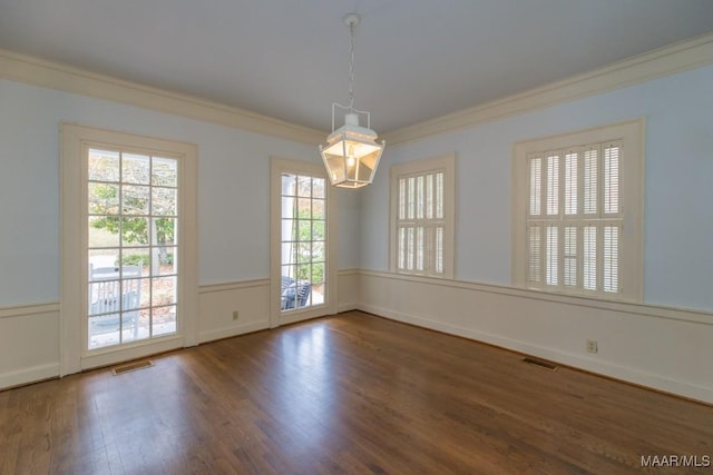 unfurnished room featuring ornamental molding, a healthy amount of sunlight, visible vents, and dark wood-type flooring