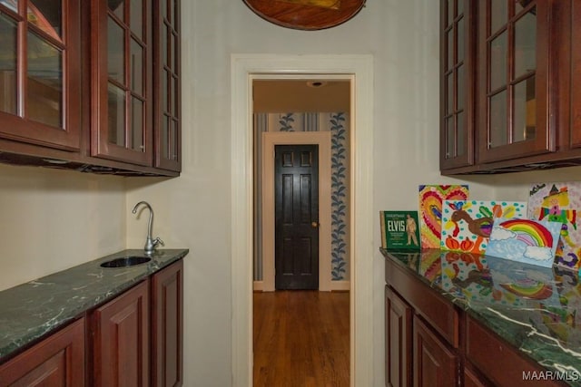 bar with dark wood-style floors and a sink