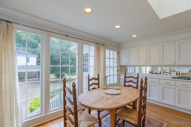 dining room with crown molding, light wood finished floors, and recessed lighting