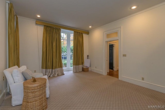 sitting room featuring crown molding, recessed lighting, baseboards, and light colored carpet