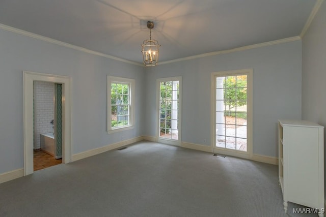 spare room with light carpet, ornamental molding, a chandelier, and baseboards