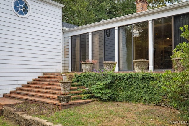 entrance to property featuring a chimney