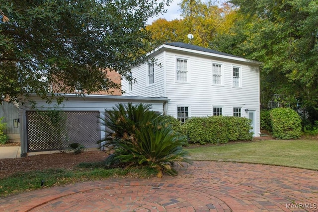 view of side of property with a patio area and a yard