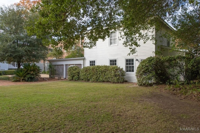 rear view of property with a yard