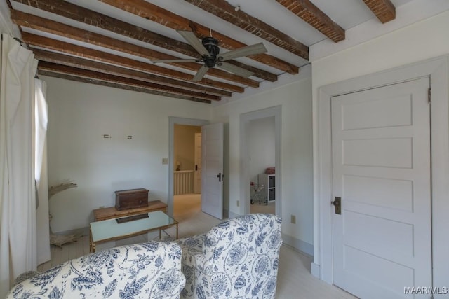 bedroom featuring beamed ceiling and baseboards