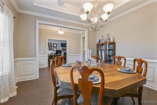 dining room with a wainscoted wall, a chandelier, dark wood-style flooring, and ornamental molding