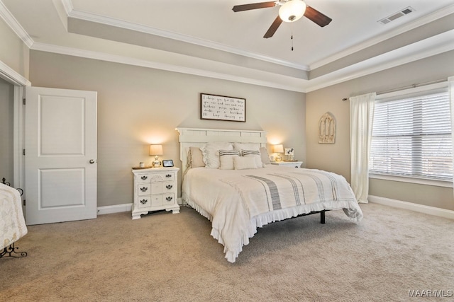 bedroom featuring a raised ceiling, visible vents, light carpet, and baseboards