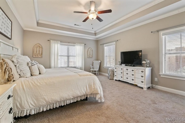 bedroom with baseboards, a raised ceiling, and light colored carpet