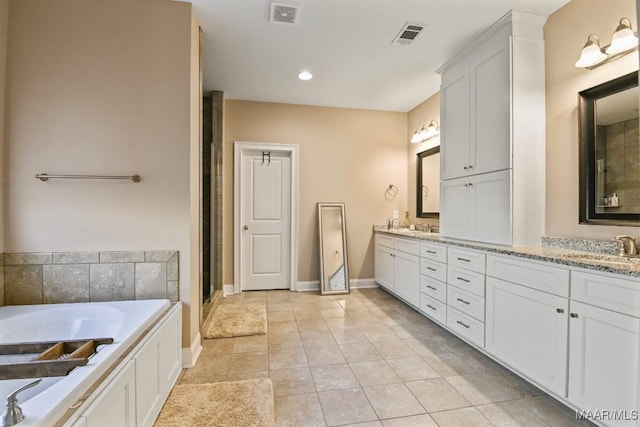 bathroom featuring double vanity, tile patterned flooring, visible vents, and a sink