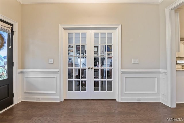 doorway featuring a decorative wall, dark wood-style flooring, and french doors