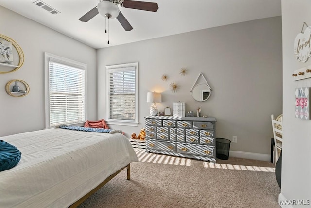 bedroom with a ceiling fan, carpet, visible vents, and baseboards