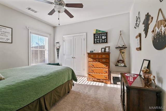 bedroom with a closet, carpet, visible vents, and a ceiling fan