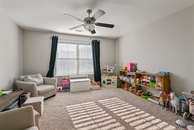 recreation room with light colored carpet, visible vents, and ceiling fan