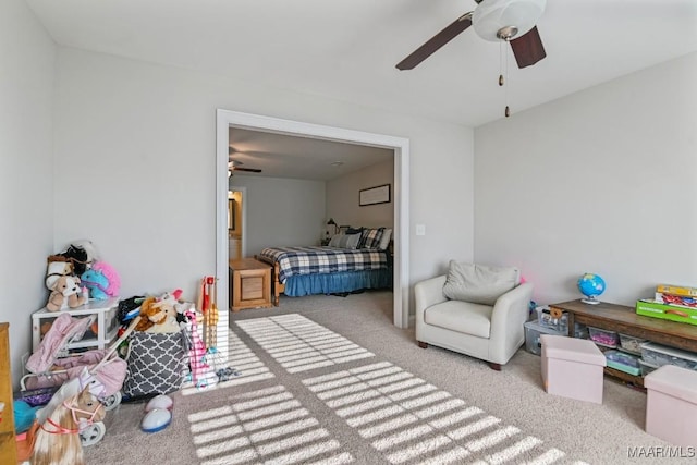 bedroom with a ceiling fan and light colored carpet