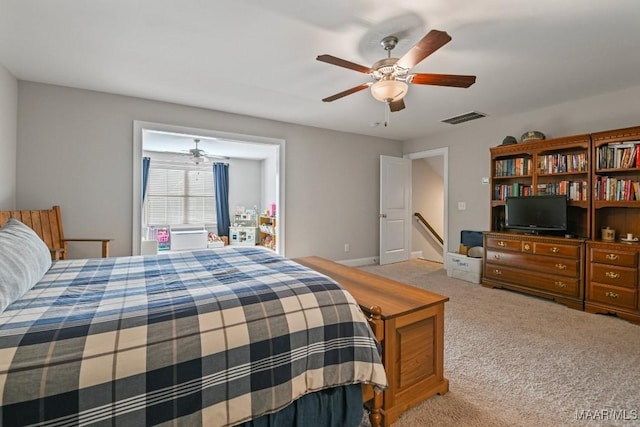 bedroom featuring a ceiling fan, visible vents, and light colored carpet