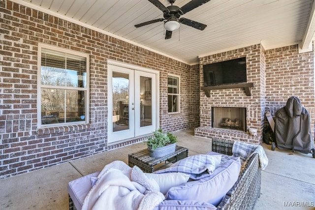 view of patio featuring an outdoor living space with a fireplace, a ceiling fan, and french doors