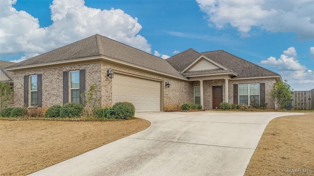 view of front of house with a garage, concrete driveway, brick siding, and a shingled roof