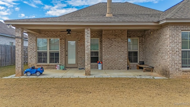 rear view of house featuring a patio, brick siding, fence, and a ceiling fan