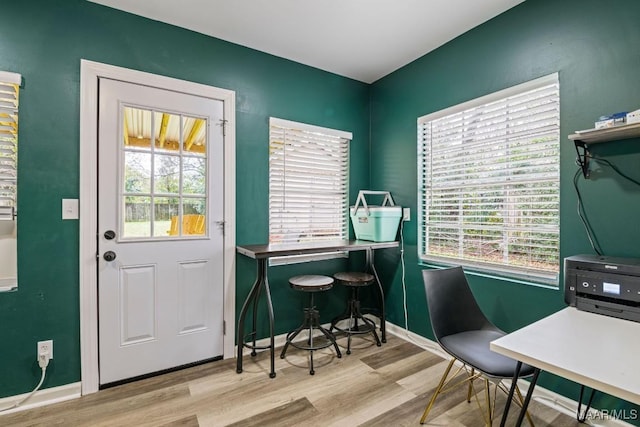 interior space with light wood finished floors and baseboards