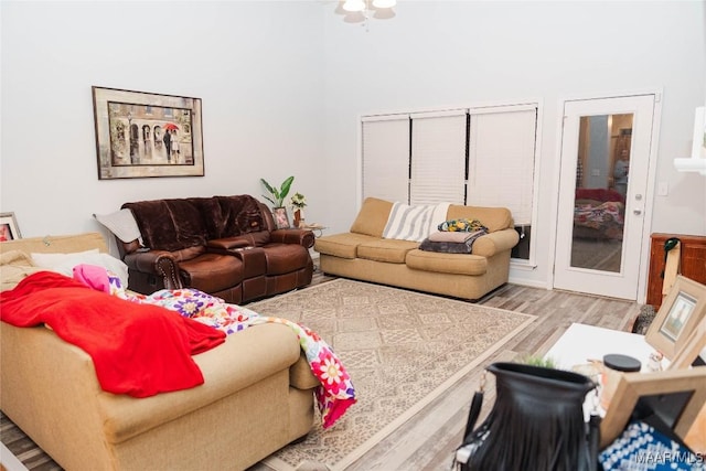 living room with a high ceiling and light wood finished floors