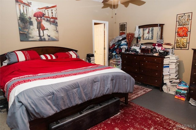 bedroom featuring ceiling fan and concrete floors