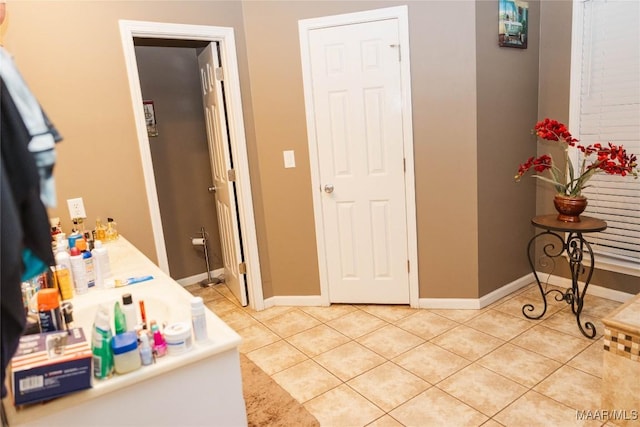 bathroom featuring tile patterned flooring and baseboards